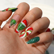 Green Xmas press-on nails worn on hand – almond shape by Handora