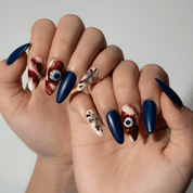 Haunted Eyes press-on nails worn on hand – almond shape by Handora