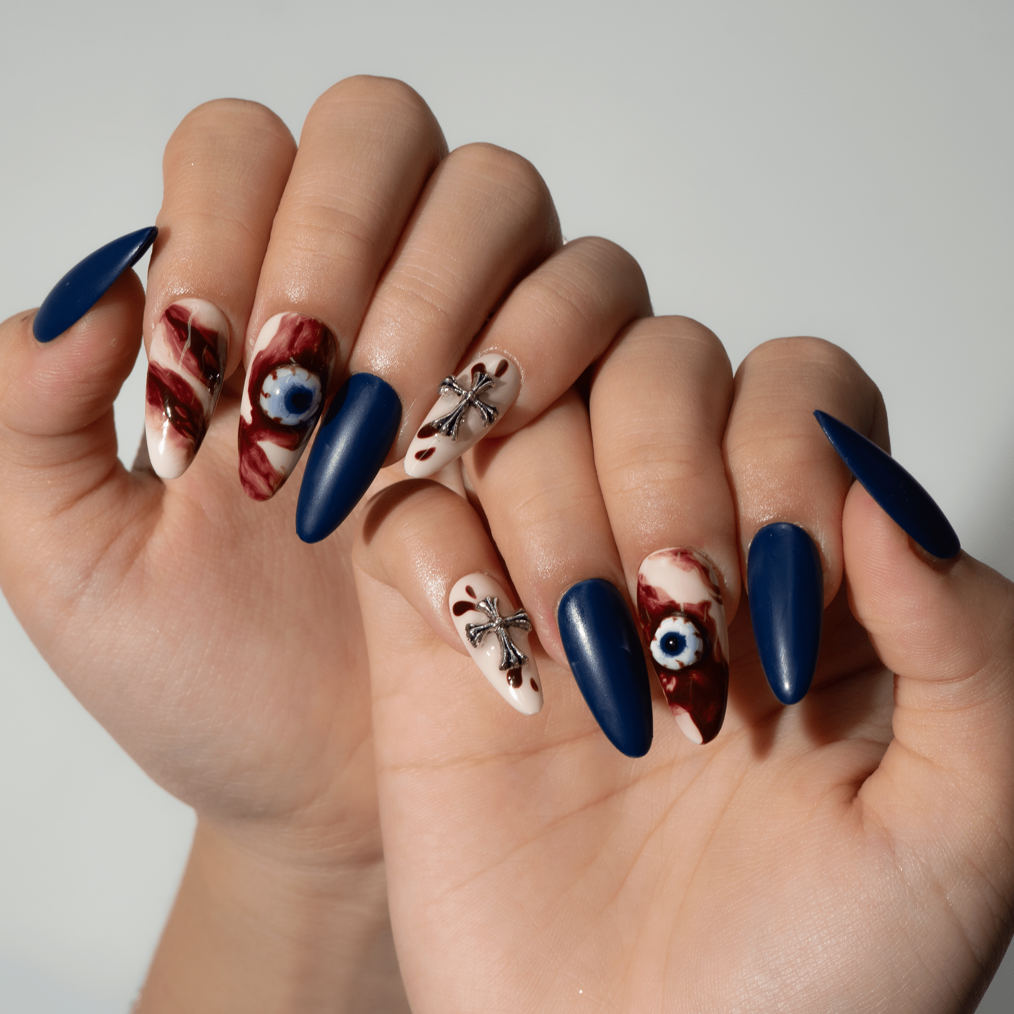 Haunted Eyes press-on nails worn on hand – almond shape by Handora