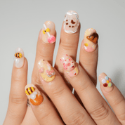 Honey Bear press-on nails worn on hand – almond shape by Handora