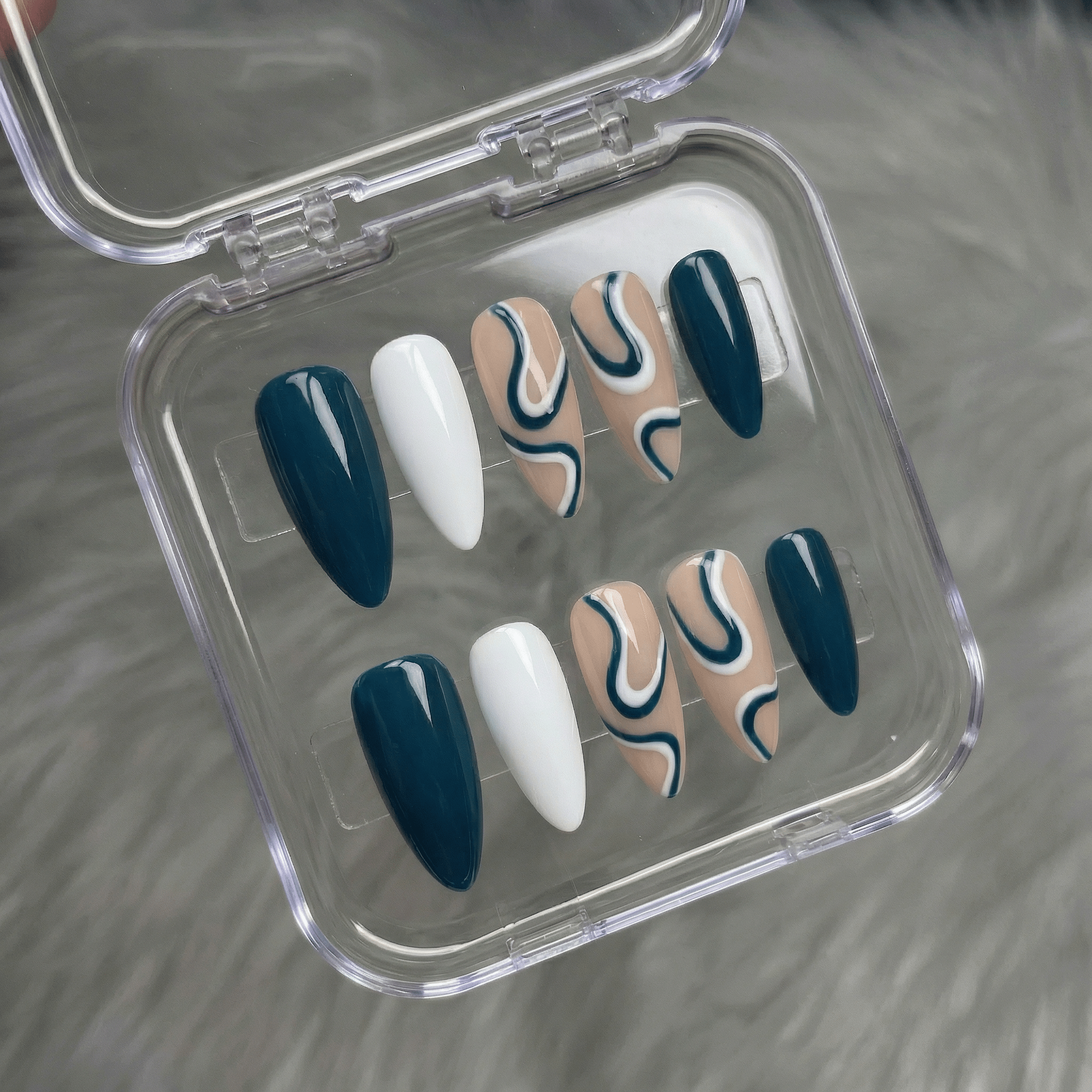 Jade Wave press-on nails worn on hand – almond shape by Handora