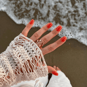 Juicy Strawberry press-on nails worn on hand – almond shape by Handora
