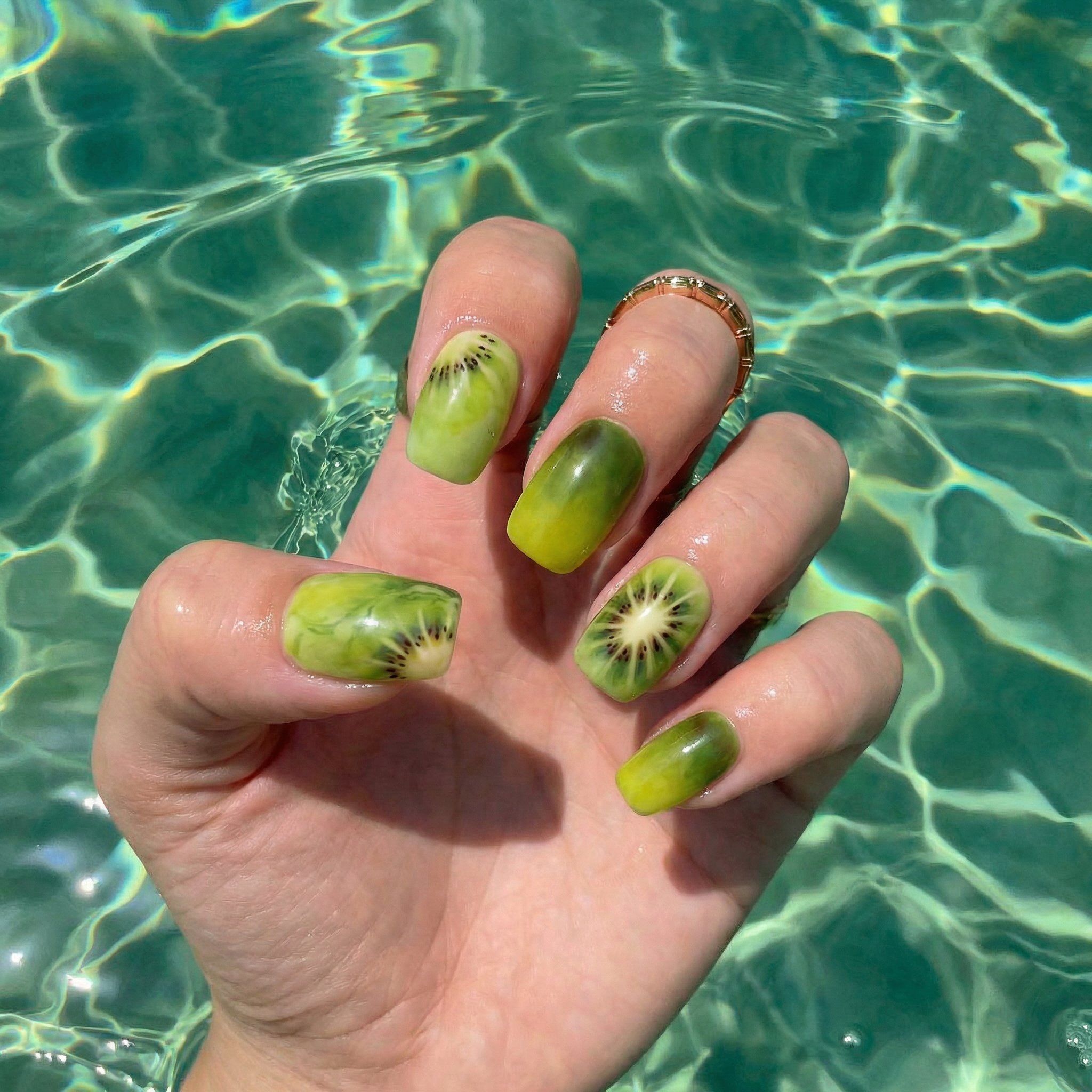 Kiwi Crush press-on nails worn on hand – almond shape by Handora
