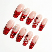 Ladybug Blossom press-on nails worn on hand – coffin shape by Handora