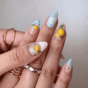 Lemon Splash press-on nails worn on hand – almond shape by Handora