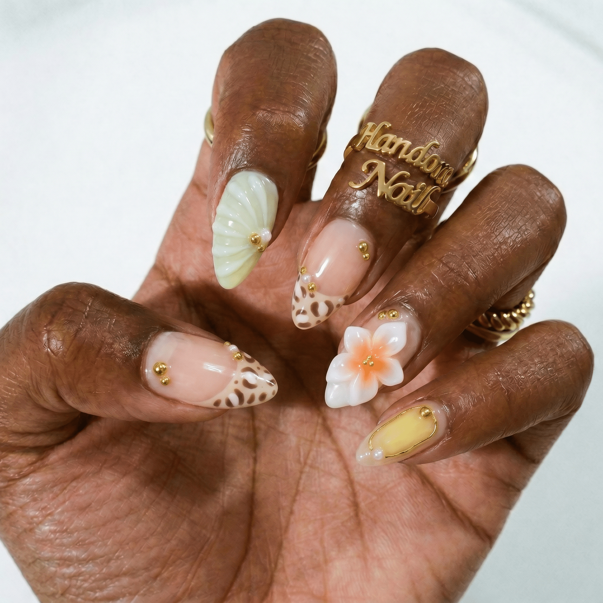 Leopard Flower press-on nails worn on hand – almond shape by Handora
