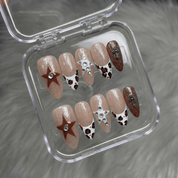 Leopard Stars press-on nails worn on hand – almond shape by Handora