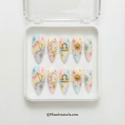 Libra Ethereal press-on nails worn on hand – almond shape by Handora