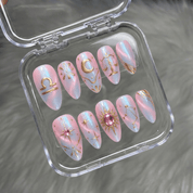 Libra Muse press-on nails worn on hand – almond shape by Handora