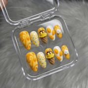 Mango Sundae press-on nails worn on hand – almond shape by Handora
