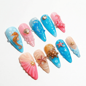 Marine Abyss press-on nails worn on hand – almond shape by Handora
