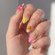 Marine Blossom press-on nails worn on hand – almond shape by Handora