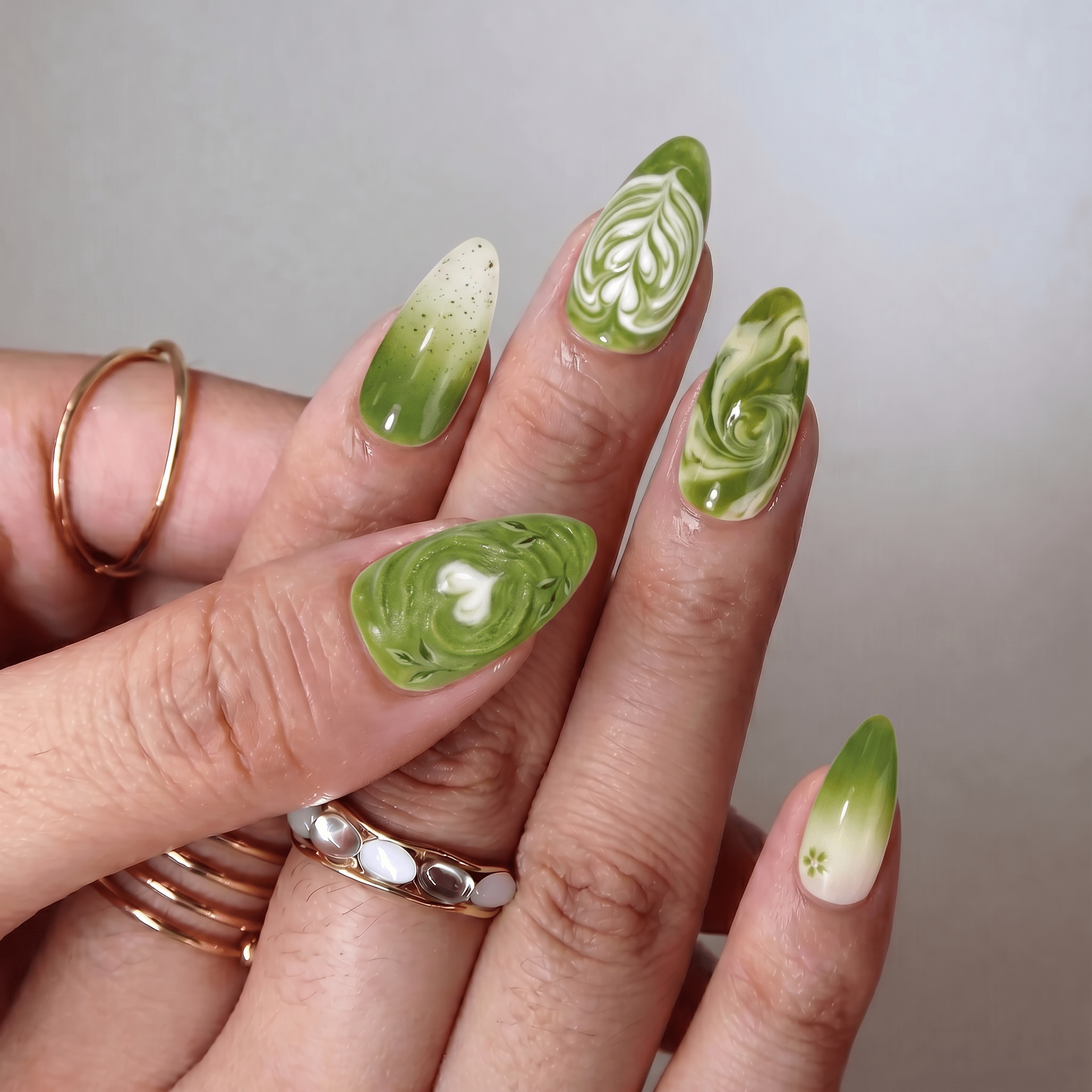 Matcha Latte press-on nails worn on hand – almond shape by Handora