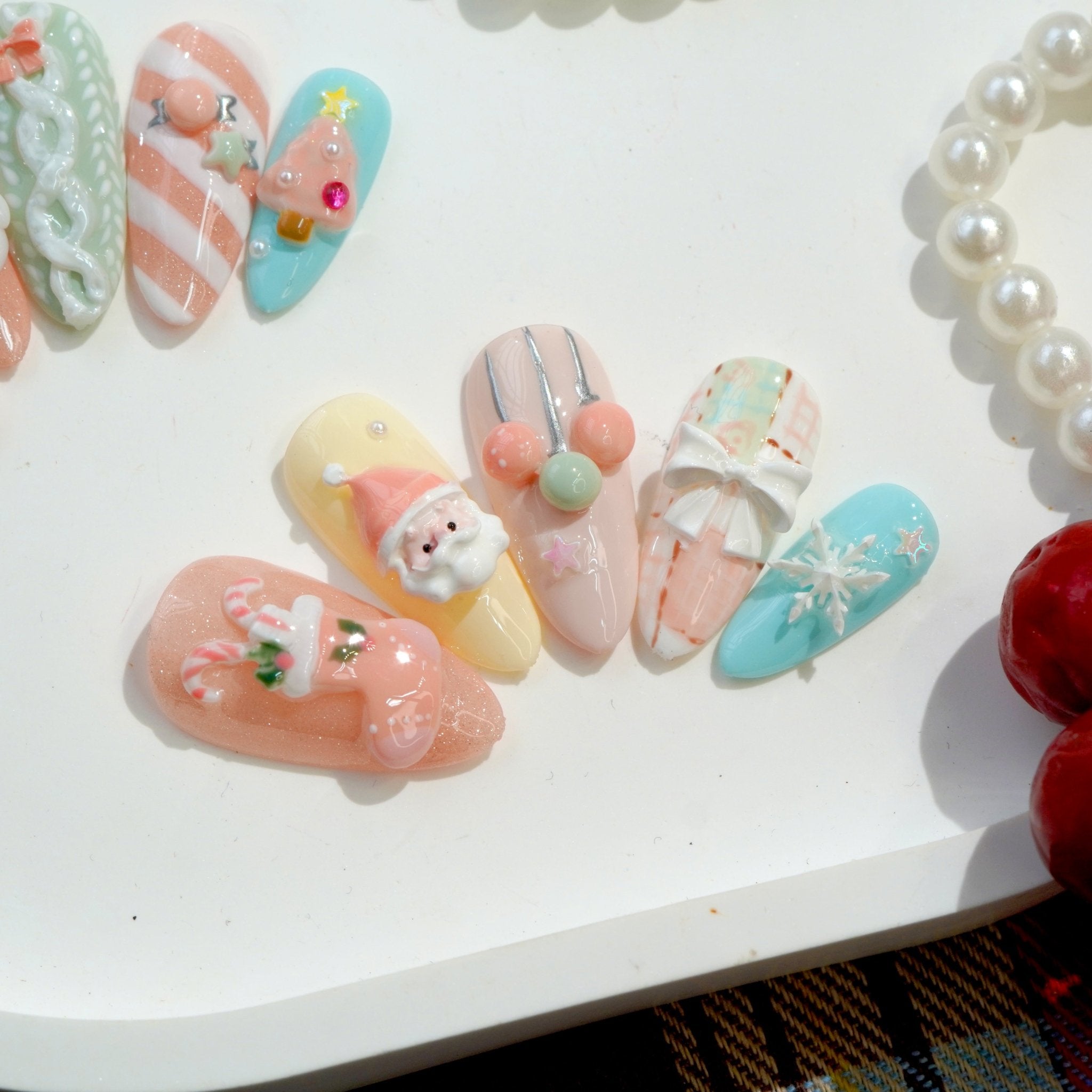 Merry Pastel press-on nails worn on hand – almond shape by Handora