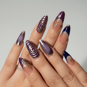 Midnight Charm press-on nails worn on hand – almond shape by Handora