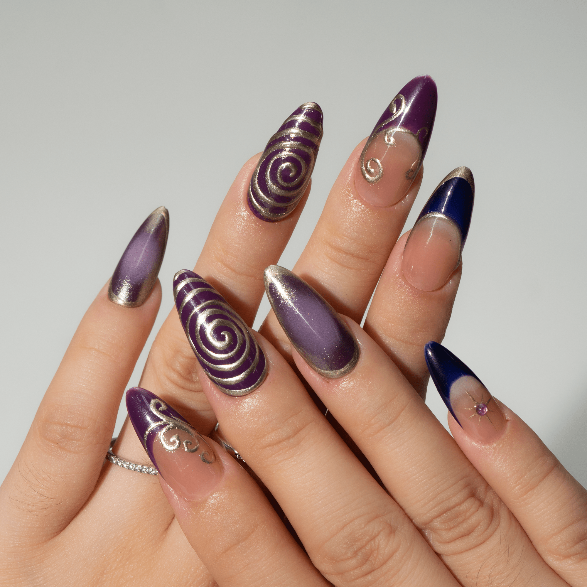 Midnight Charm press-on nails worn on hand – almond shape by Handora