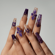 Midnight Orchid press-on nails worn on hand – almond shape by Handora