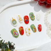 Mistletoe Magic press-on nails worn on hand – oval shape by Handora