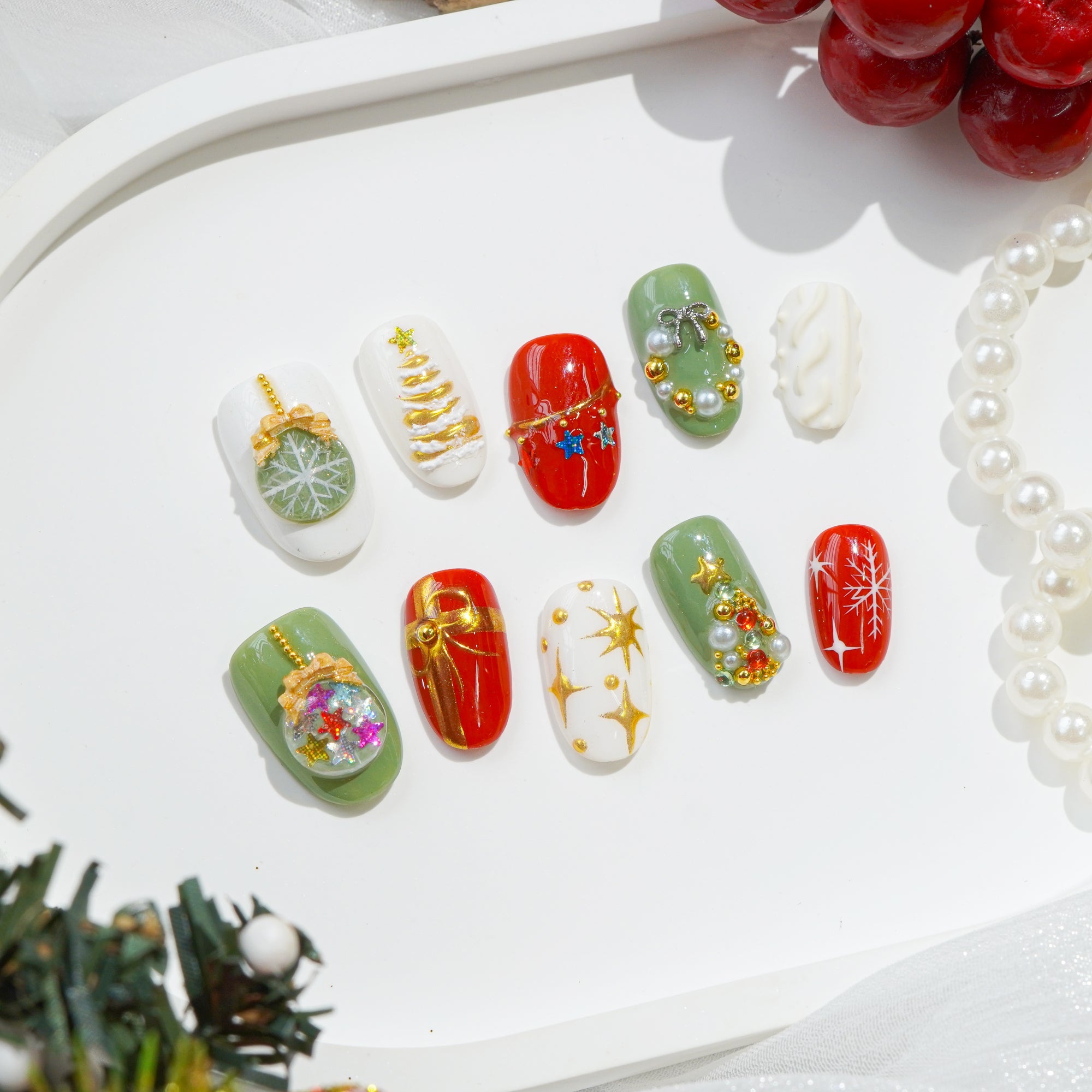 Mistletoe Magic press-on nails worn on hand – oval shape by Handora