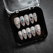 Molten Jewels press-on nails worn on hand – almond shape by Handora