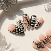 Music Muse press-on nails worn on hand – almond shape by Handora