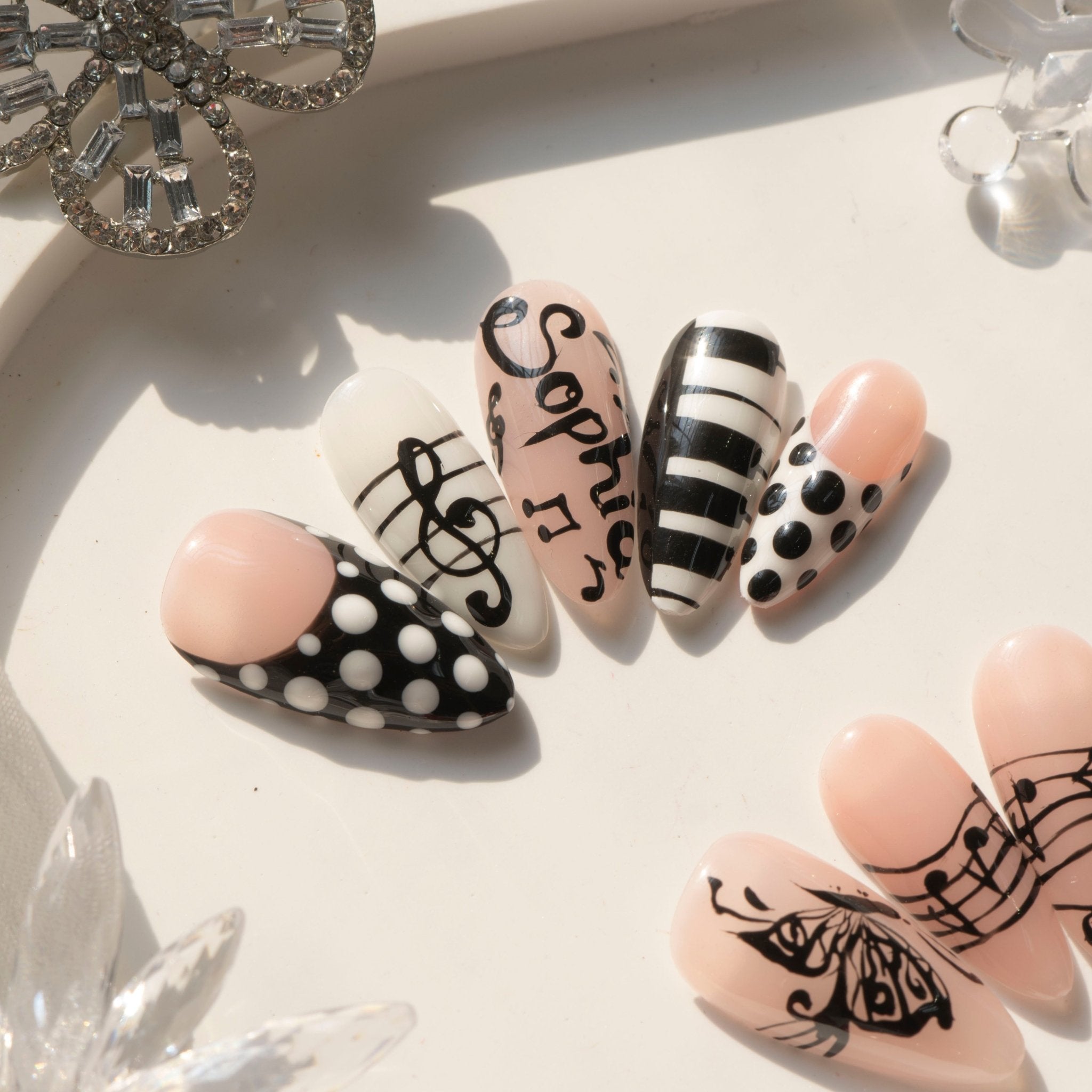 Music Muse press-on nails worn on hand – almond shape by Handora