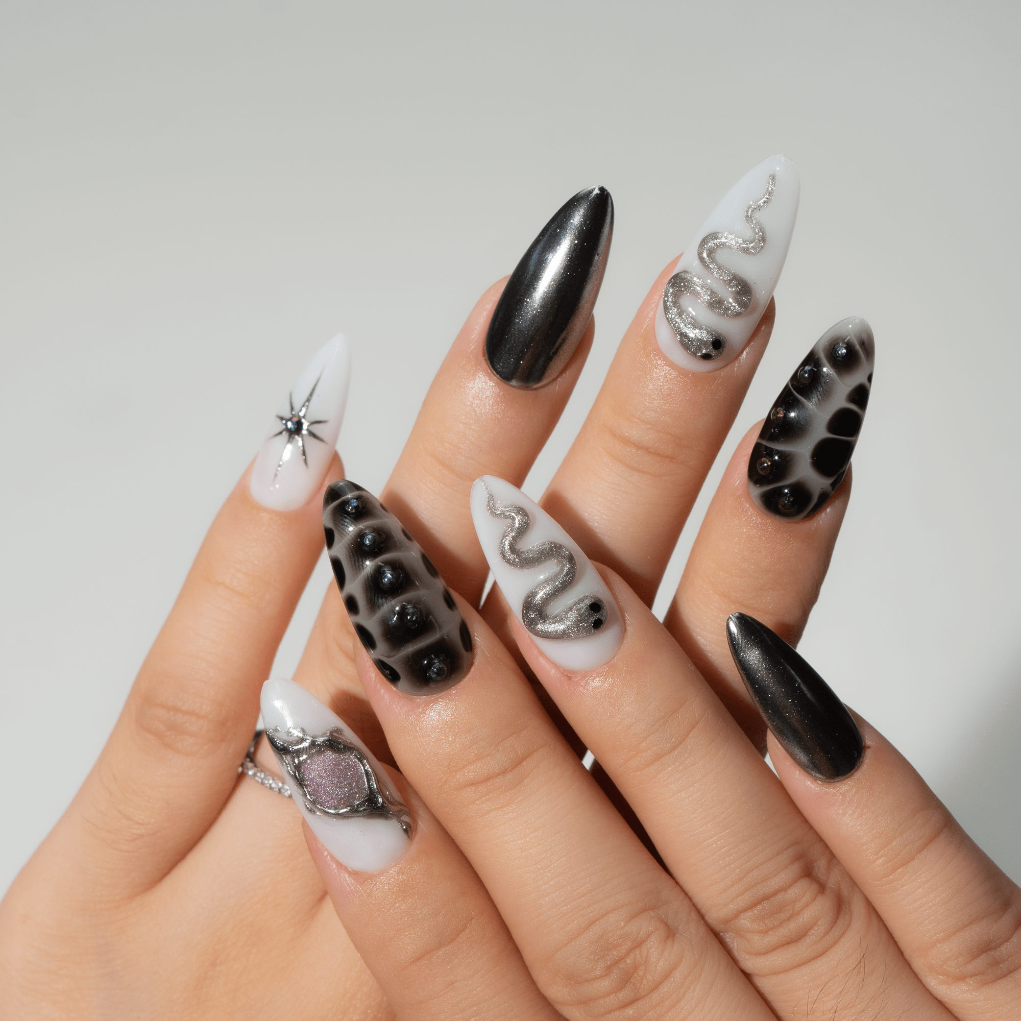 Mystic Fang press-on nails worn on hand – almond shape by Handora