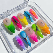 Neon Drip press-on nails worn on hand – almond shape by Handora