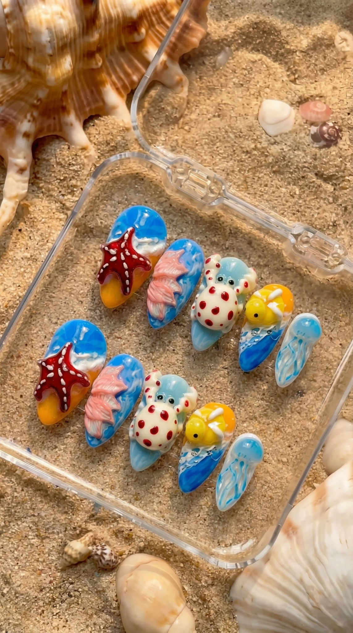 Ocean Creatures press-on nails worn on hand – almond shape by Handora