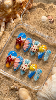 Ocean Creatures press-on nails worn on hand – almond shape by Handora