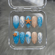 Ocean Mermaid press-on nails worn on hand – almond shape by Handora