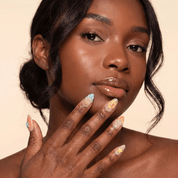 Ocean Oasis press-on nails worn on hand – almond shape by Handora