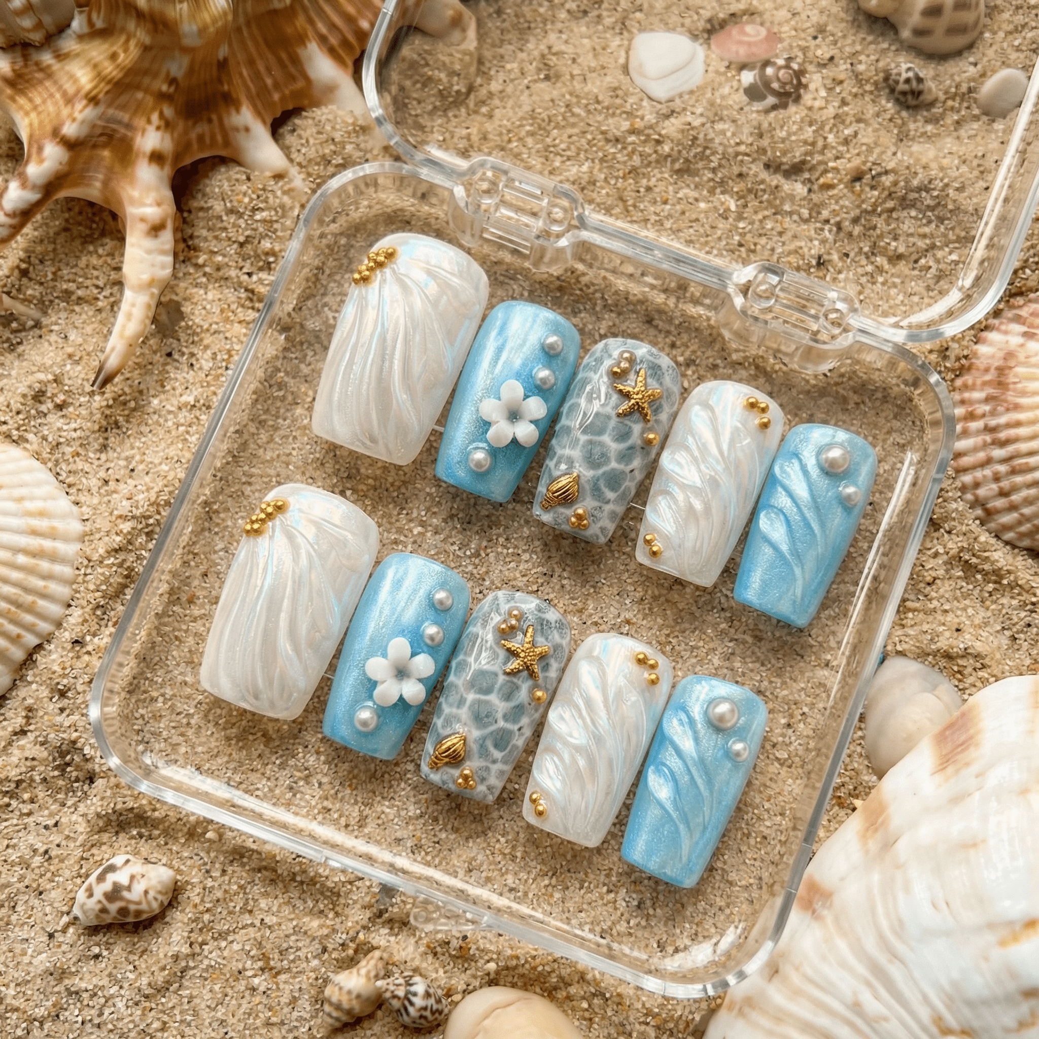 Ocean Pearl press-on nails worn on hand – coffin shape by Handora