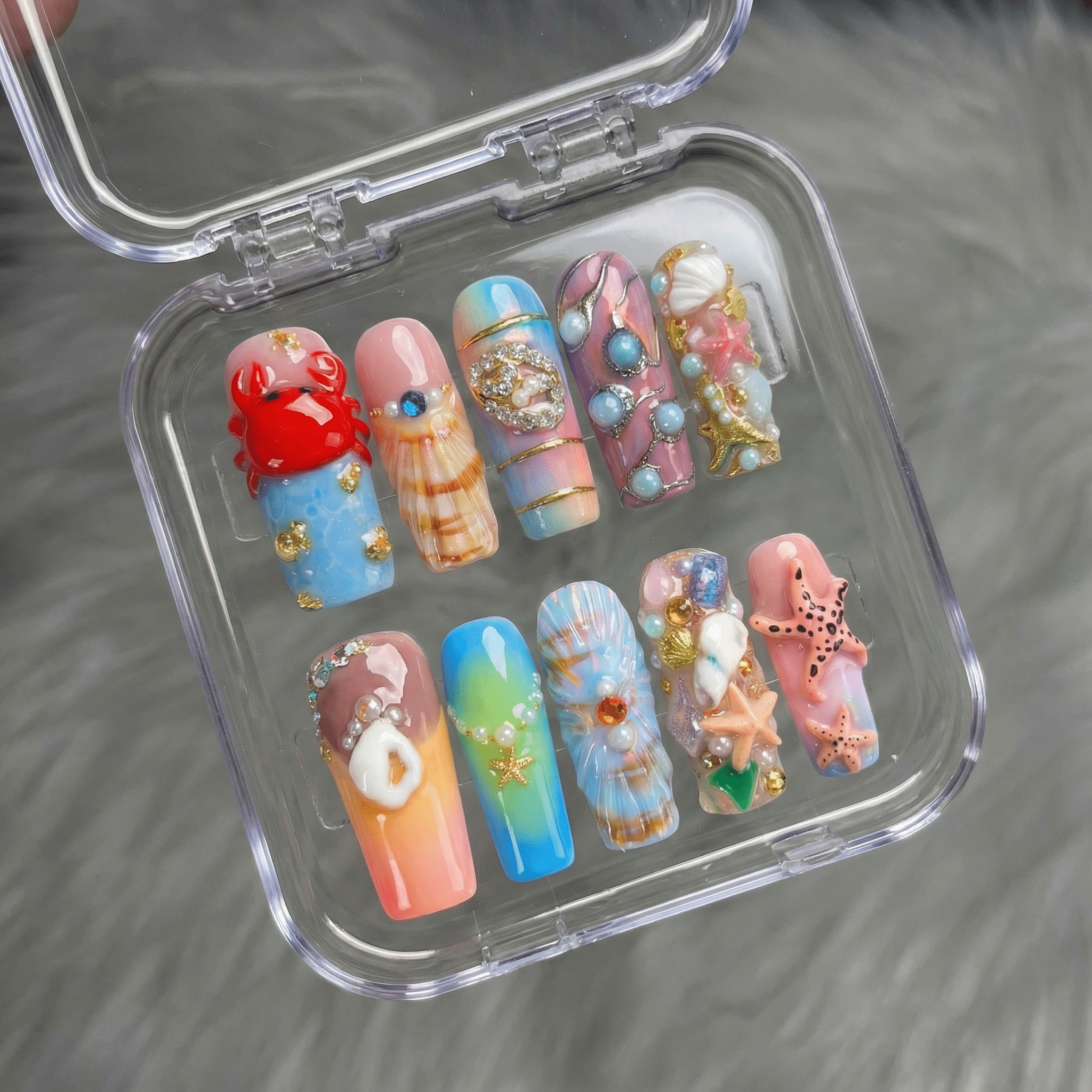 Ocean Reef press-on nails worn on hand – square shape by Handora