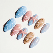Ocean Siren press-on nails worn on hand – almond shape by Handora