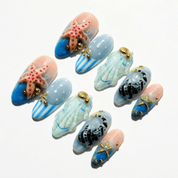 Ocean Whispers press-on nails worn on hand – almond shape by Handora