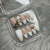 Oceanic Safari press-on nails worn on hand – almond shape by Handora