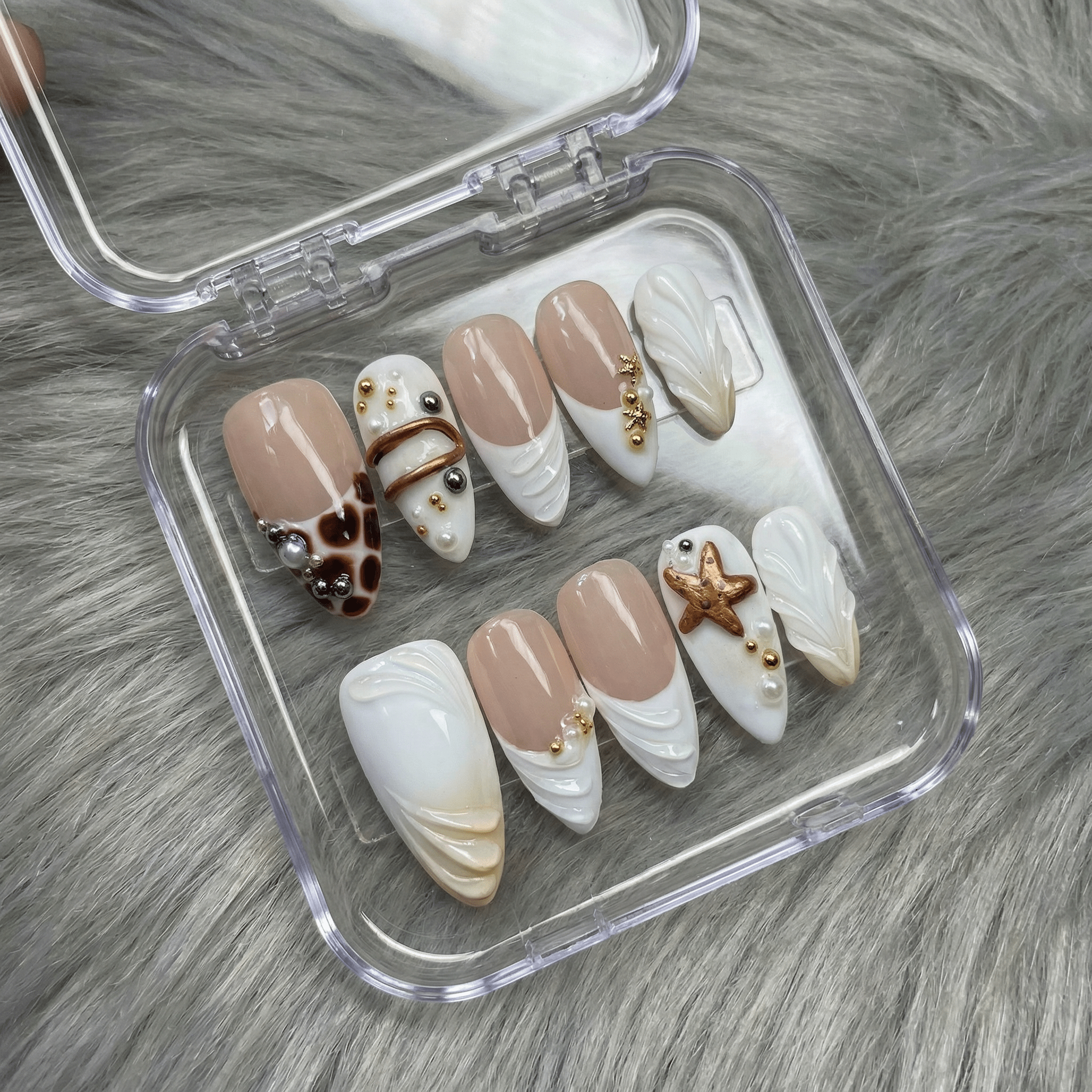 Oceanic Safari press-on nails worn on hand – almond shape by Handora