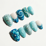 Oceanic Serenity press-on nails worn on hand – almond shape by Handora