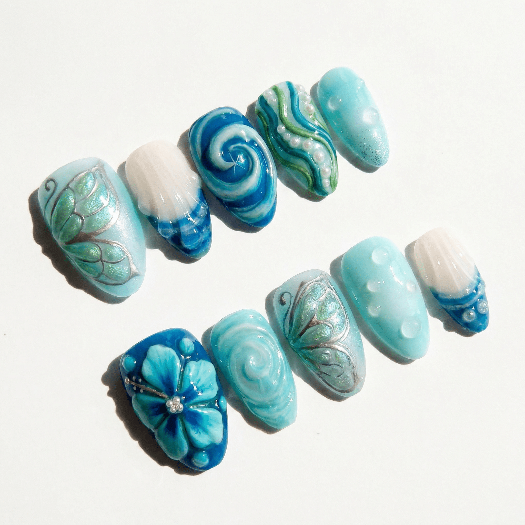 Oceanic Serenity press-on nails worn on hand – almond shape by Handora