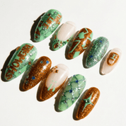 Opalite Stars press-on nails worn on hand – almond shape by Handora