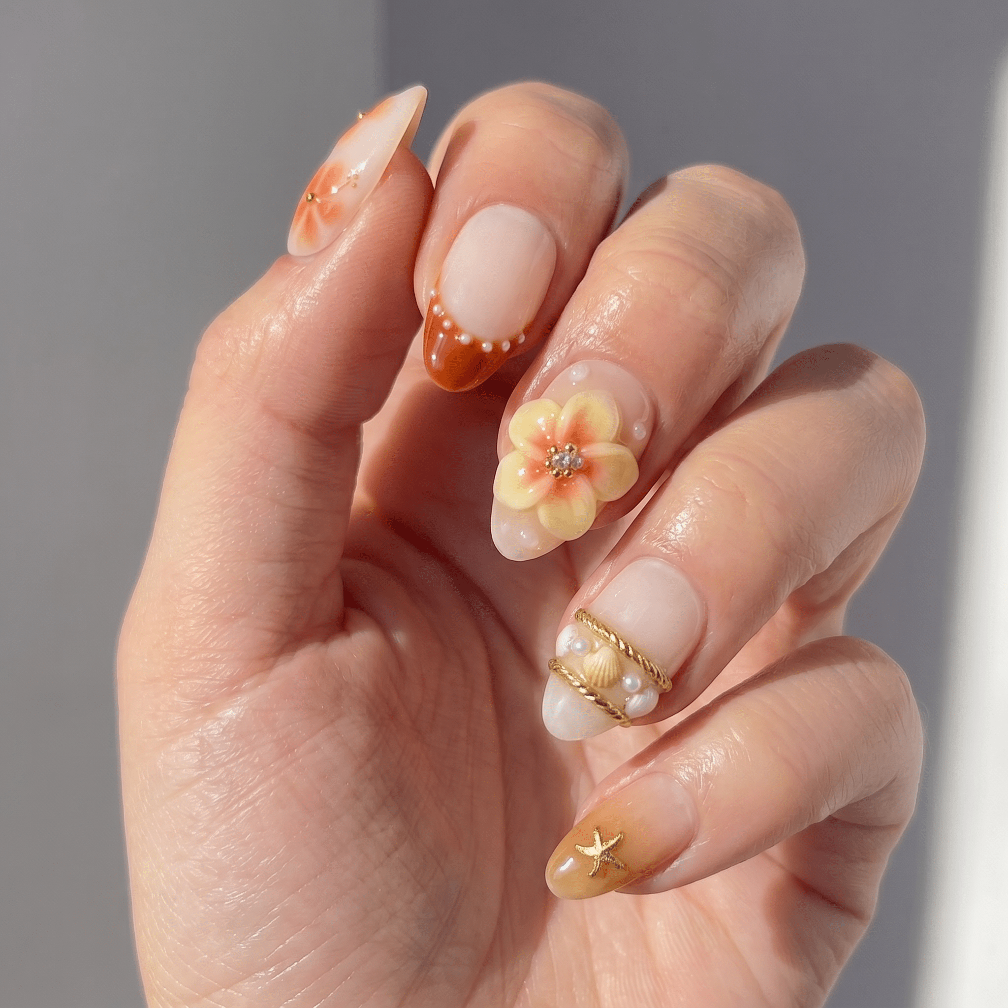 Peach Nectar press-on nails worn on hand – almond shape by Handora