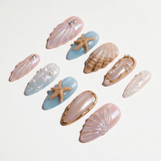 Pearl Mermaid press-on nails worn on hand – almond shape by Handora