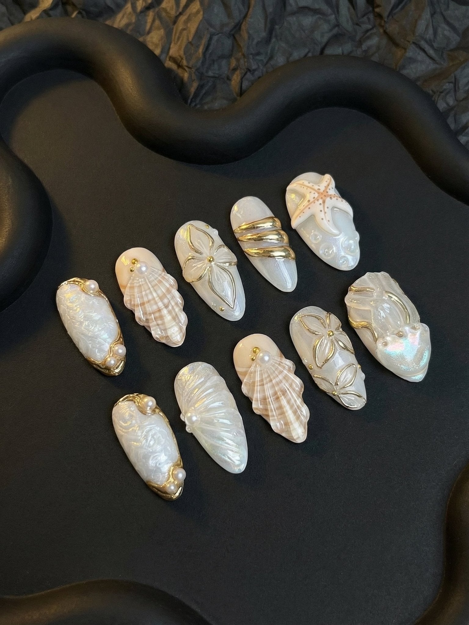 Pearl Tides press-on nails worn on hand – almond shape by Handora