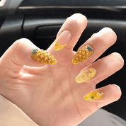 Pineapple Paradise press-on nails worn on hand – almond shape by Handora