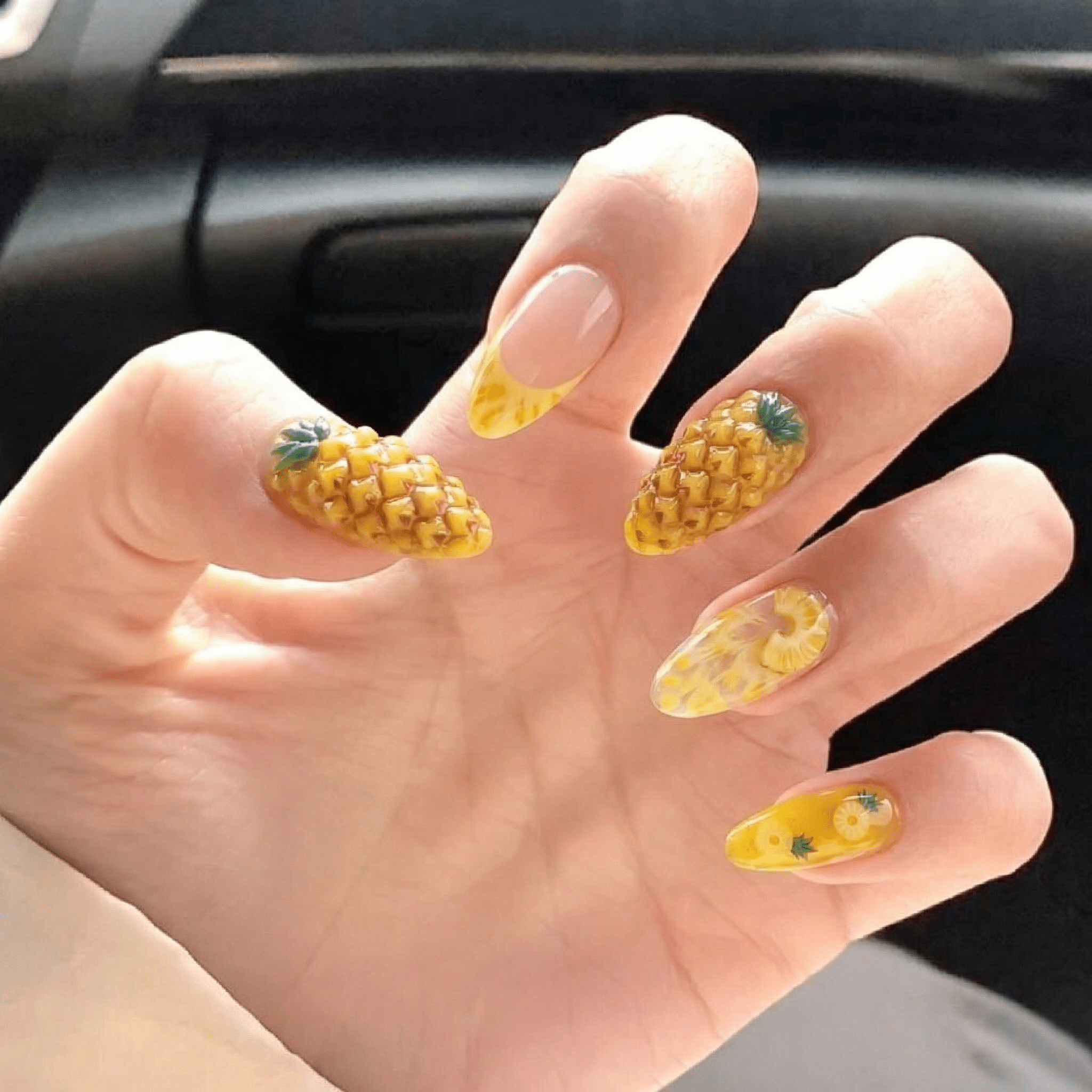 Pineapple Paradise press-on nails worn on hand – almond shape by Handora