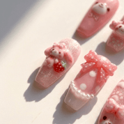 Pink Bunny press-on nails worn on hand – coffin shape by Handora