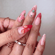 Pink Drink press-on nails worn on hand – almond shape by Handora