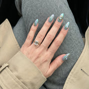 Pisces Aura press-on nails worn on hand – almond shape by Handora
