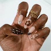 Polka Bloom press-on nails worn on hand – almond shape by Handora